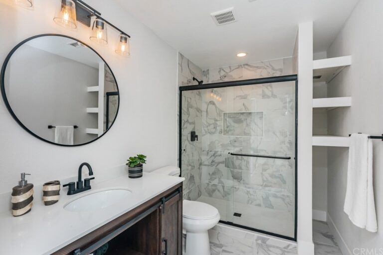 white bathroom w/ dark cabinets